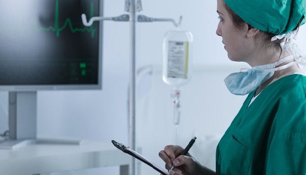 Doctor checking patient heartbeat