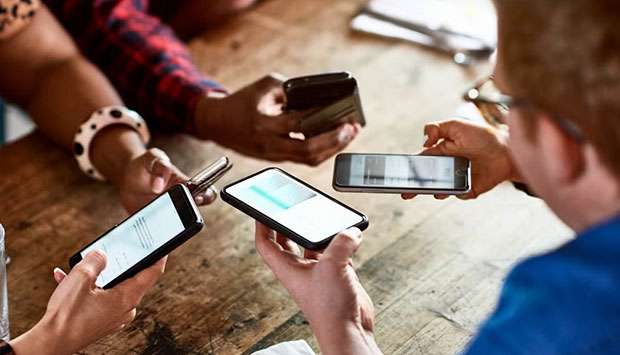 People using smartphones together